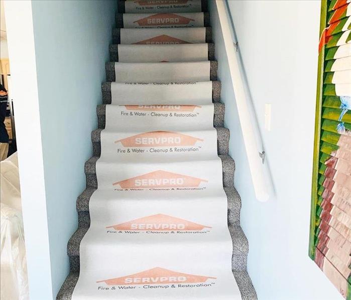 we are protecting the stairs & bottom level so we keep things clean throughout the cleanup.
